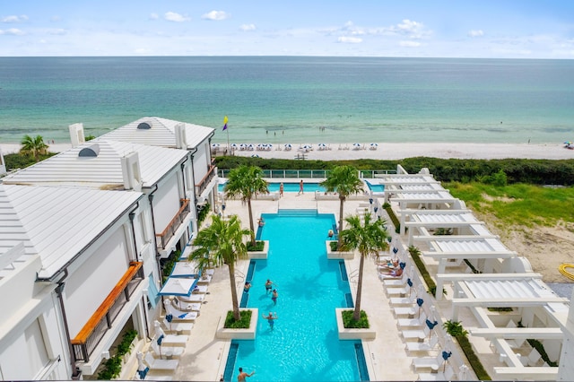 bird's eye view with a water view and a beach view