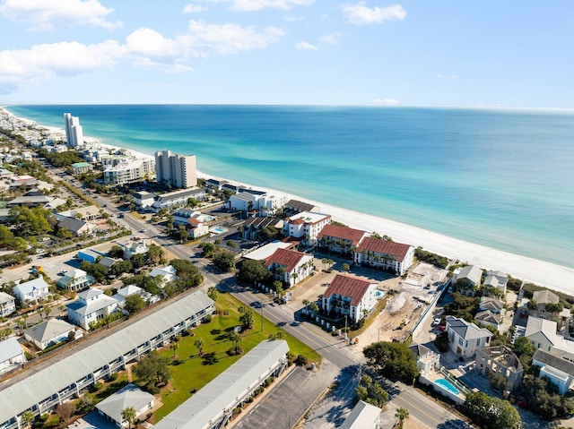 birds eye view of property with a water view and a beach view