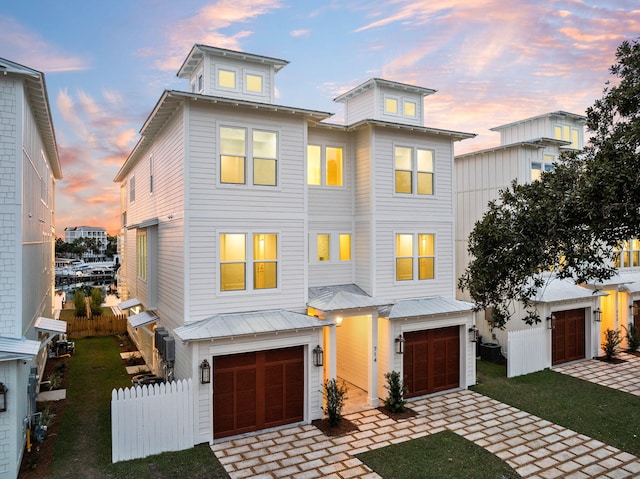 view of front of property featuring a garage and a lawn