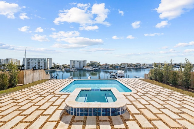 view of swimming pool featuring an in ground hot tub, a dock, a water view, and a patio