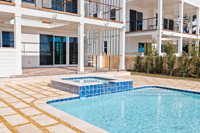 view of swimming pool featuring an in ground hot tub