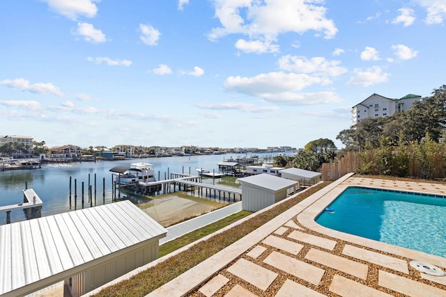 view of pool with a dock, a water view, and a patio