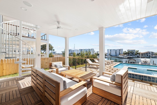 view of patio / terrace with ceiling fan, a fenced in pool, a balcony, an outdoor living space, and a water view