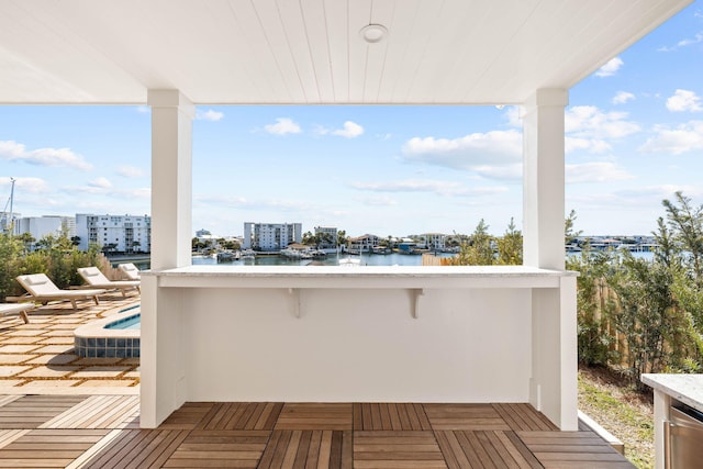 wooden terrace featuring a water view