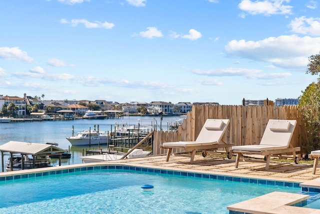 view of swimming pool with a water view