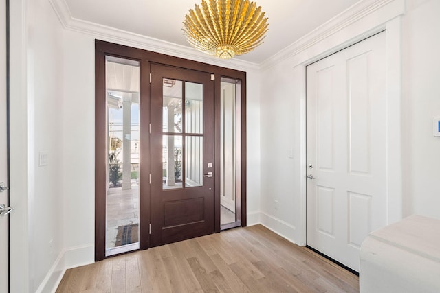 foyer with crown molding and light hardwood / wood-style flooring