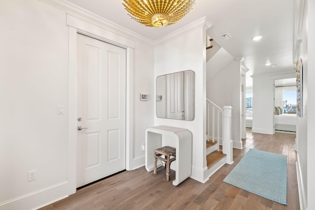 entrance foyer featuring light hardwood / wood-style floors and ornamental molding