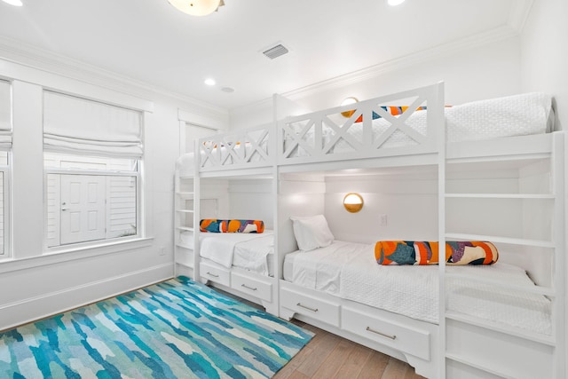 bedroom featuring crown molding and hardwood / wood-style floors