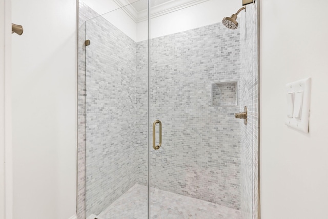 bathroom featuring an enclosed shower and ornamental molding