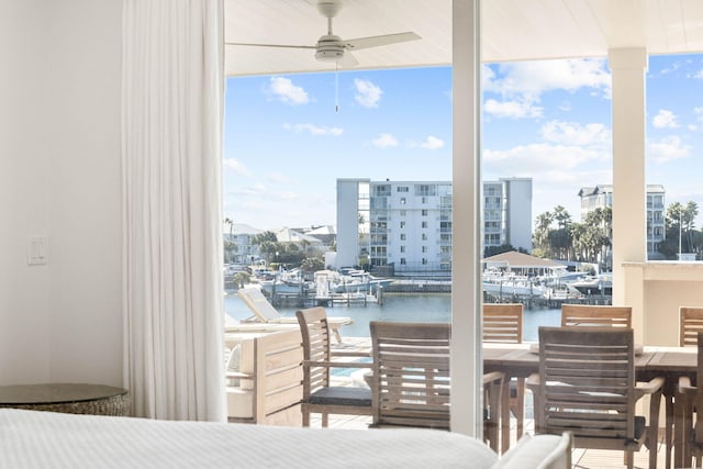 bedroom with floor to ceiling windows and a water view