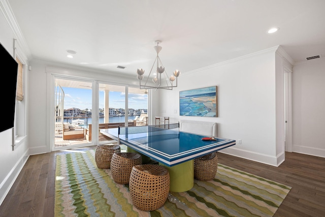 rec room with ornamental molding, a water view, and dark hardwood / wood-style flooring