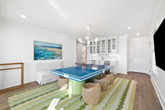 recreation room featuring crown molding and hardwood / wood-style flooring