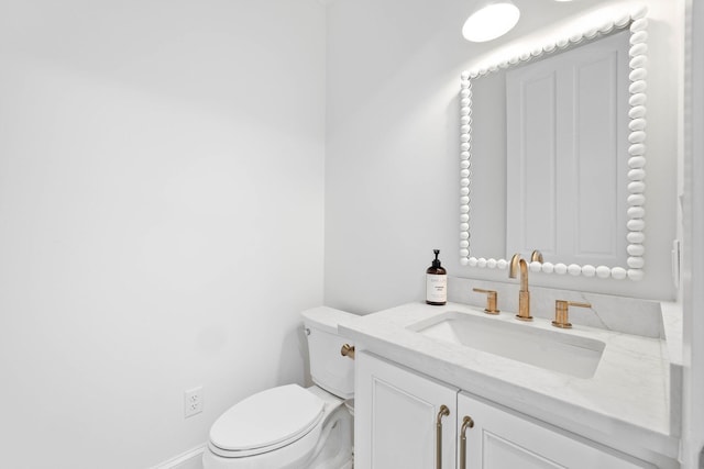 bathroom featuring toilet and vanity