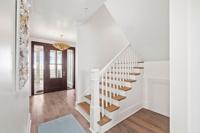 entrance foyer featuring hardwood / wood-style floors and crown molding