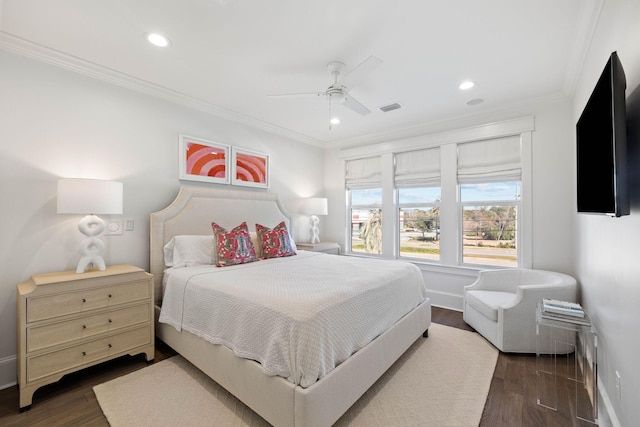 bedroom with ceiling fan, dark hardwood / wood-style flooring, and ornamental molding