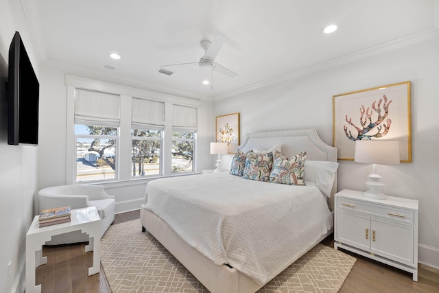 bedroom featuring dark wood-type flooring, ceiling fan, and crown molding