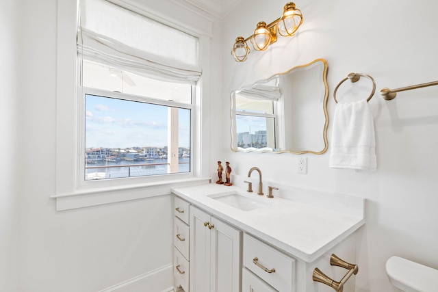 bathroom featuring toilet, a water view, and vanity