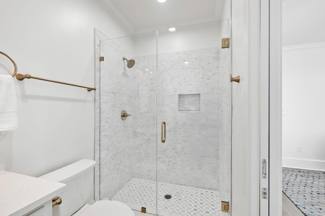 bathroom with a shower with shower door, toilet, vanity, and ornamental molding