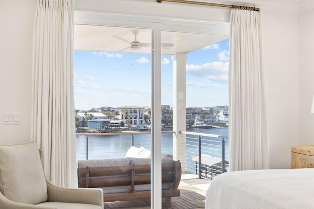 bedroom featuring a water view, multiple windows, and ornamental molding