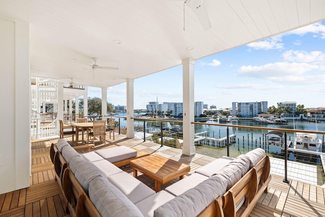 view of patio / terrace featuring ceiling fan, a water view, and an outdoor hangout area