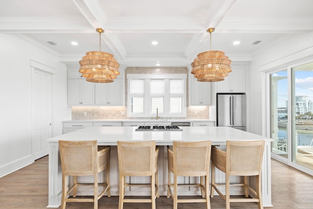 kitchen with appliances with stainless steel finishes, a notable chandelier, and a large island