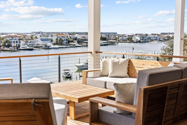 balcony featuring an outdoor living space and a water view