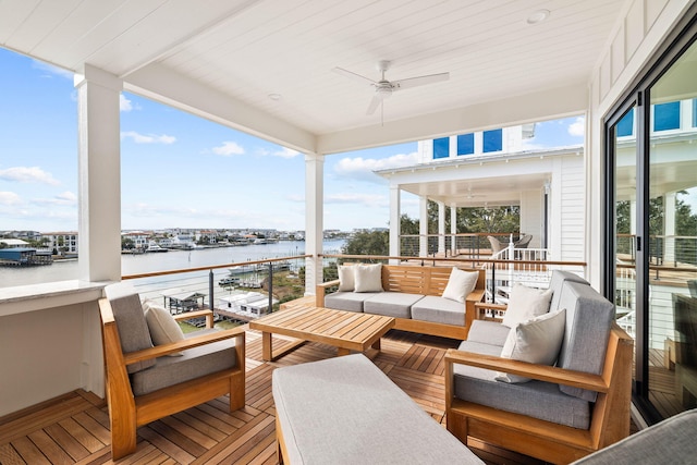 sunroom / solarium with ceiling fan, a healthy amount of sunlight, and a water view