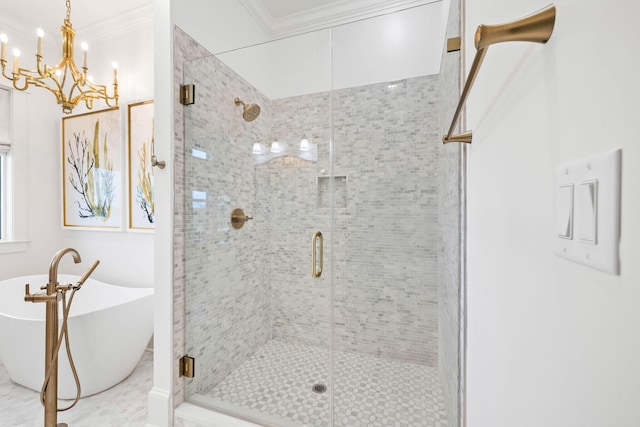 bathroom with an inviting chandelier, ornamental molding, and separate shower and tub