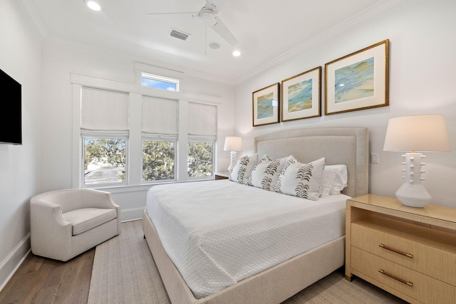 bedroom featuring ceiling fan, ornamental molding, and hardwood / wood-style floors