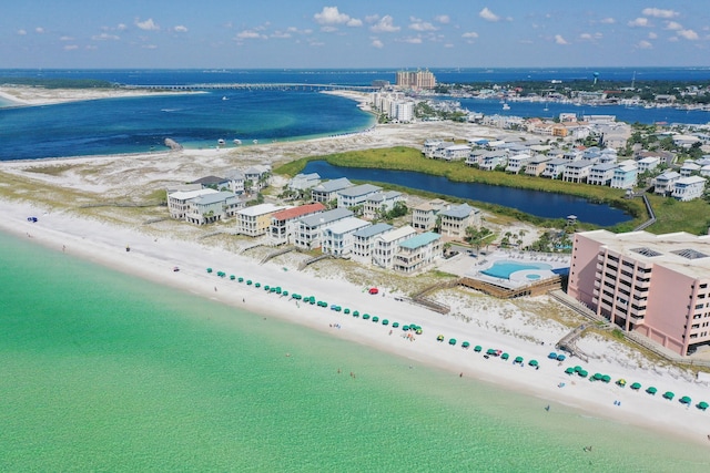 bird's eye view featuring a water view and a beach view