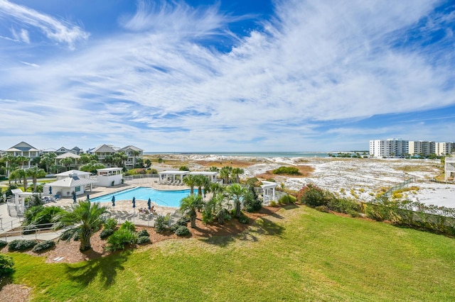 view of pool featuring a water view and a lawn