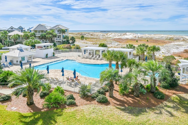 view of swimming pool with a water view, a gazebo, a patio, and a beach view