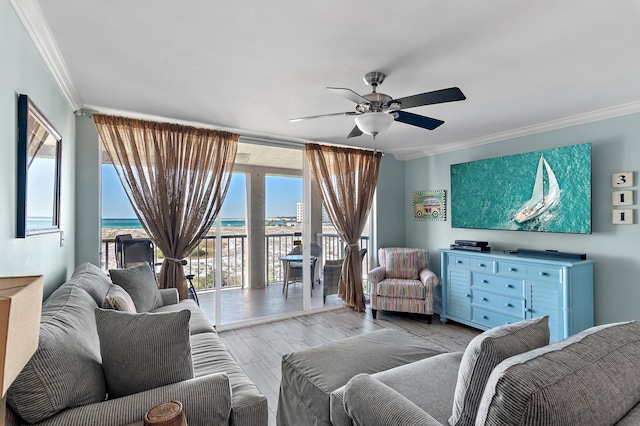 living room with ceiling fan, crown molding, and a water view