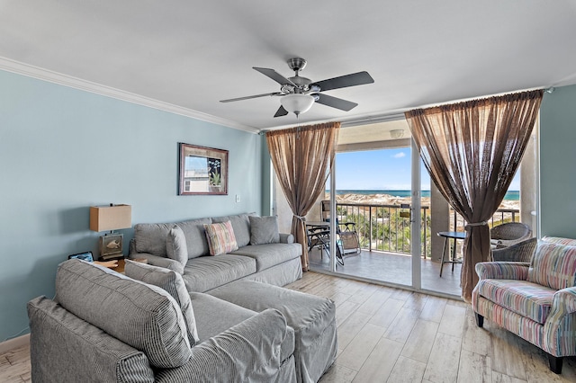 living room with crown molding, a wall of windows, and ceiling fan