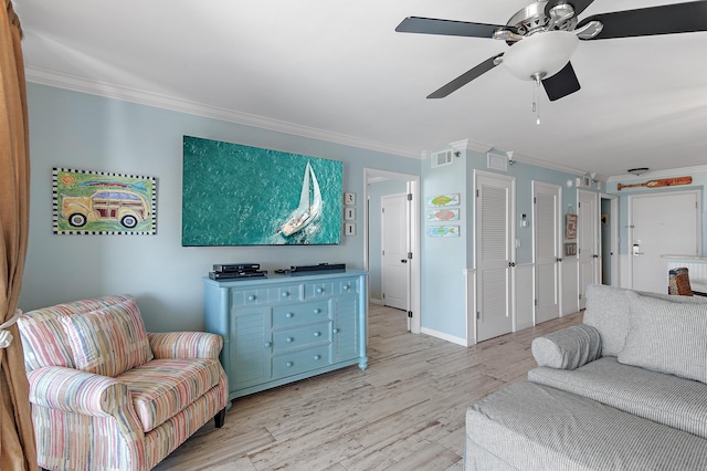 living room featuring light wood-type flooring, ceiling fan, and crown molding