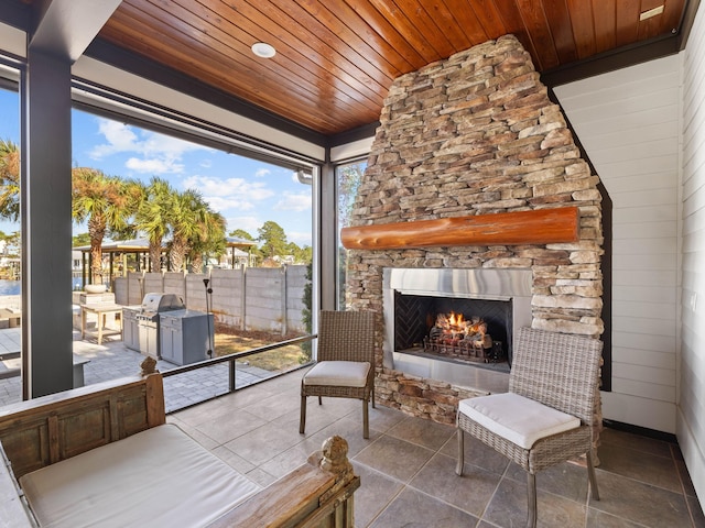 view of patio with an outdoor stone fireplace, grilling area, and an outdoor kitchen