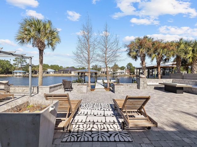 view of community featuring a water view and a patio