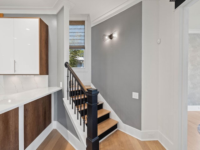 stairs with wood finished floors and baseboards