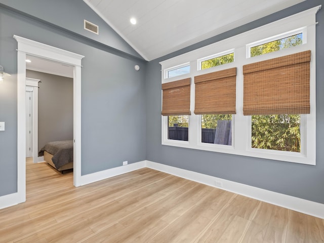 unfurnished room featuring recessed lighting, wood finished floors, visible vents, baseboards, and vaulted ceiling