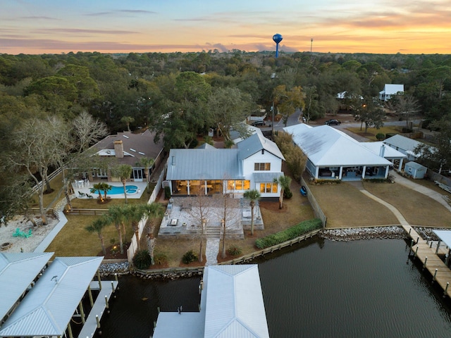 aerial view at dusk with a water view