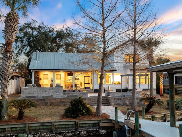 back of house with metal roof