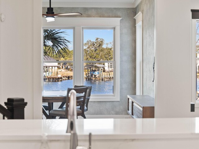 interior space featuring a water view and ceiling fan