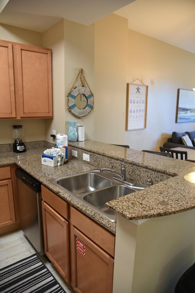 kitchen featuring sink, stainless steel dishwasher, kitchen peninsula, and stone countertops