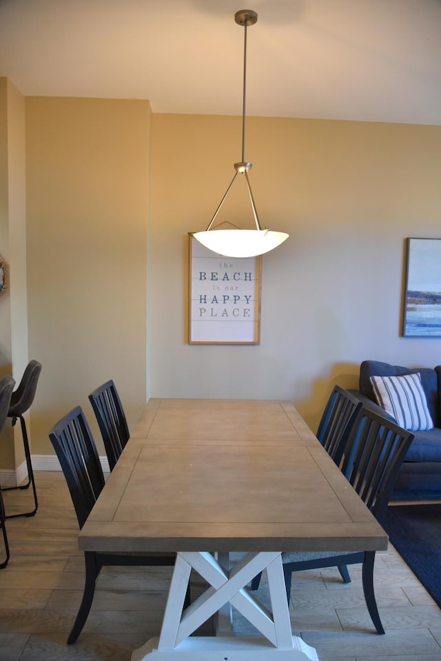 dining space with wood-type flooring