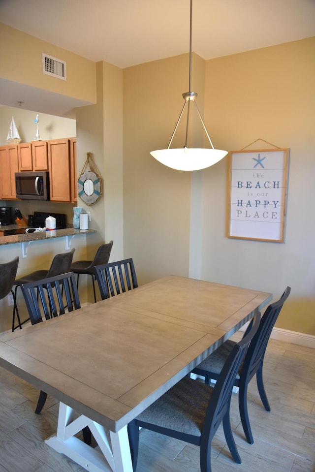 dining space with light hardwood / wood-style flooring