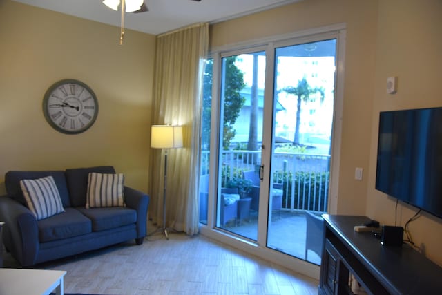 living room with ceiling fan and light wood-type flooring