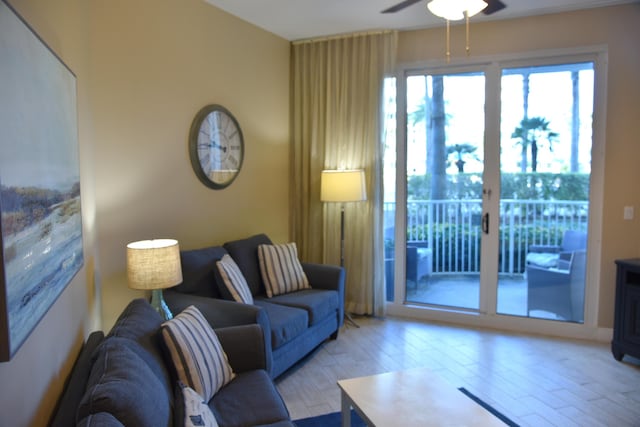 living room with light hardwood / wood-style floors and ceiling fan