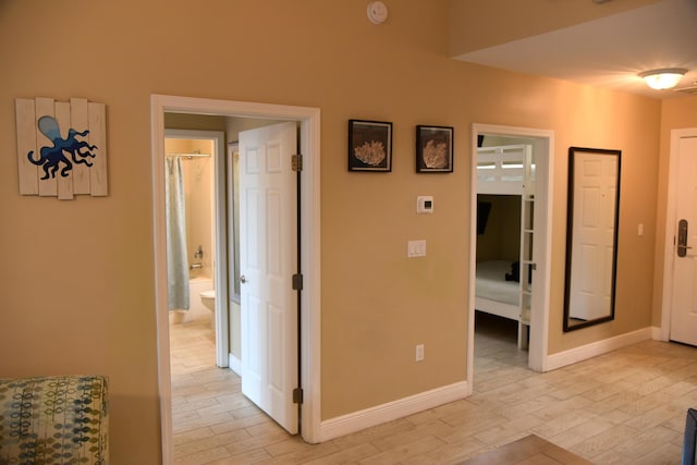 corridor with light hardwood / wood-style flooring