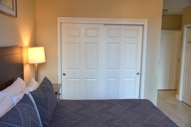 bedroom with hardwood / wood-style floors and a closet