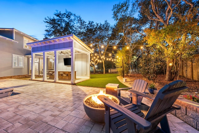 view of patio featuring an outbuilding and an outdoor fire pit